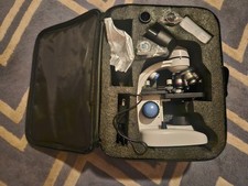 used binocular microscope good condition, case and slides included