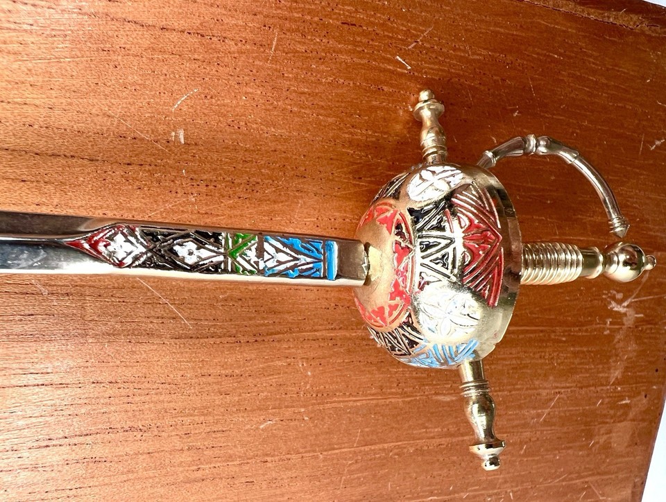 A hand-crafted Toledo Spain miniature sword letter opener — a piece of actual Iberian metalsmithing tradition sitting on your desk.