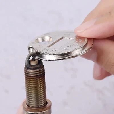 Gapping a spark plug with a coin-type gap tool