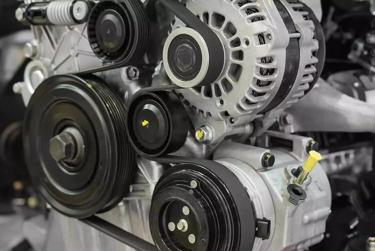 A modern engine with the serpentine belt snaking around an engine’s pulleys.