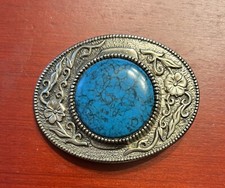 Round Turquoise color centerpiece on ornate western silver toned belt buckle