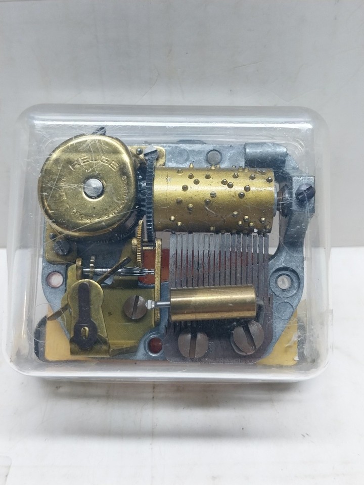 A genuine Reuge miniature Swiss movement playing 'The Entertainer' — the gold standard of vintage music boxes in a pocket-sized format.