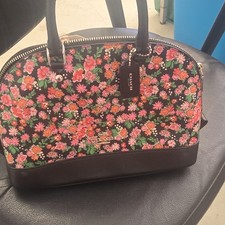  Coach Sierra Satchel features a vibrant flor...