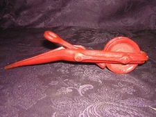 vintage red pulley with spike and rope guide