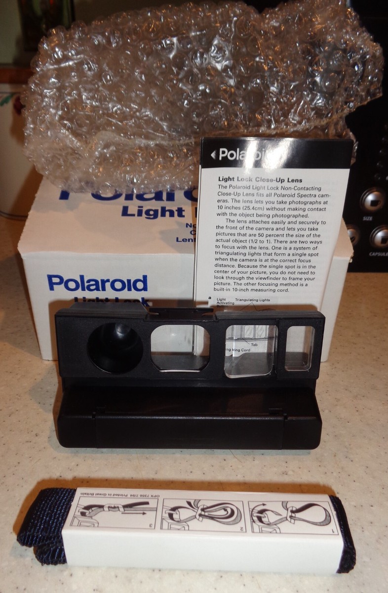 Polaroid 1200si Camera, Polaroid Bag, VHS tape, Owner's Manual, and Light Lock Polaroid 1200si Camera, Polaroid Bag, VHS tape, Owner's Manual, and Light Lock