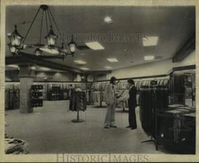 1974 Press Photo Richman Brothers men's clothing store managers check a coat