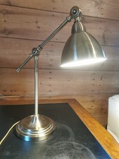 brass coloured desk lamp, adjustable with in line switch.