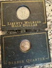 Silver - Liberty Walking half Dollar and Barber Quarter in display cases