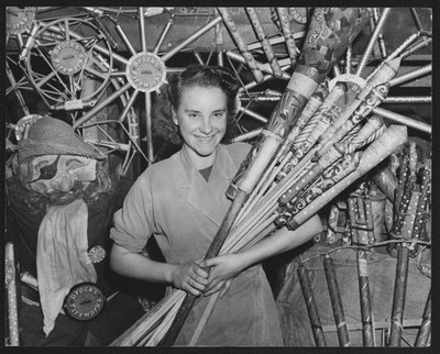 Factory worker stands and holds fireworks in Brocks Firework Facto- Old Photo