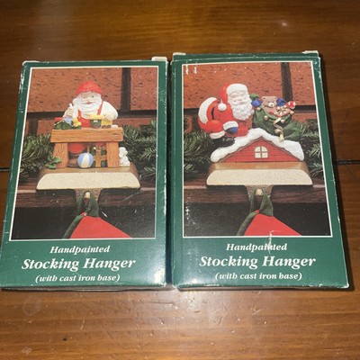 Two stocking hangers Santa Claus cast iron Christmas