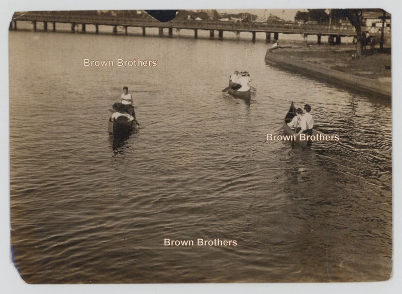 Vintage 1900s Couples Together Paddling in Canoes Along Peaceful Shore Photo