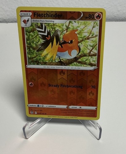 Fletchinder 028/195 Swsh12 holo card with orange-black bird artwork, gold border, and visible attack text.