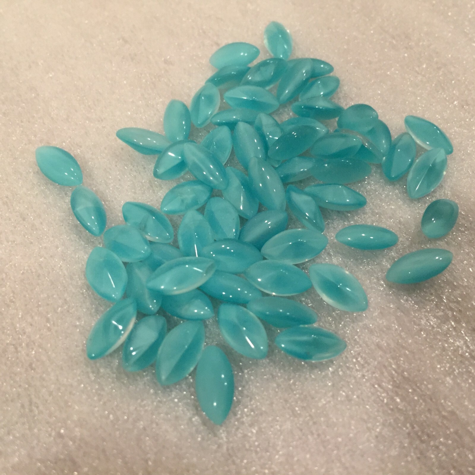 AN948 10x5mm aqua moonstone glass navettes, curved top, faceted back