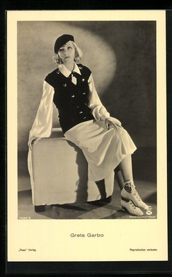 Postcard actress Greta Garbo sitting on a chairrest 
