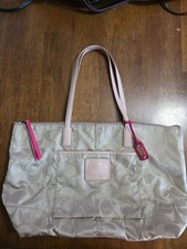 Coach tote, tan logo with pink leather details, zip closure, pockets inside