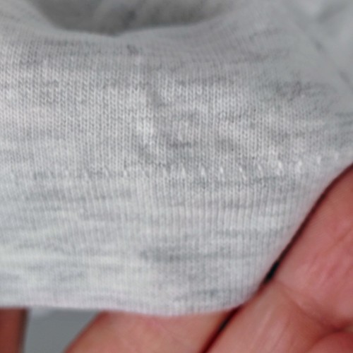Close-up of white vintage Hanes Beefy-T personnel temps inc T-shirt with single stitch and faint yellow collar mark.