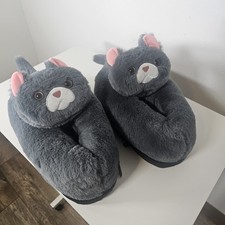 Cozy plush slippers shaped like cute gray cats. Soft faux fur with...