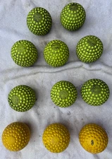 11 used dimpled pitching machine balls - 12 inch softballs.  8 Jugs and 3 others