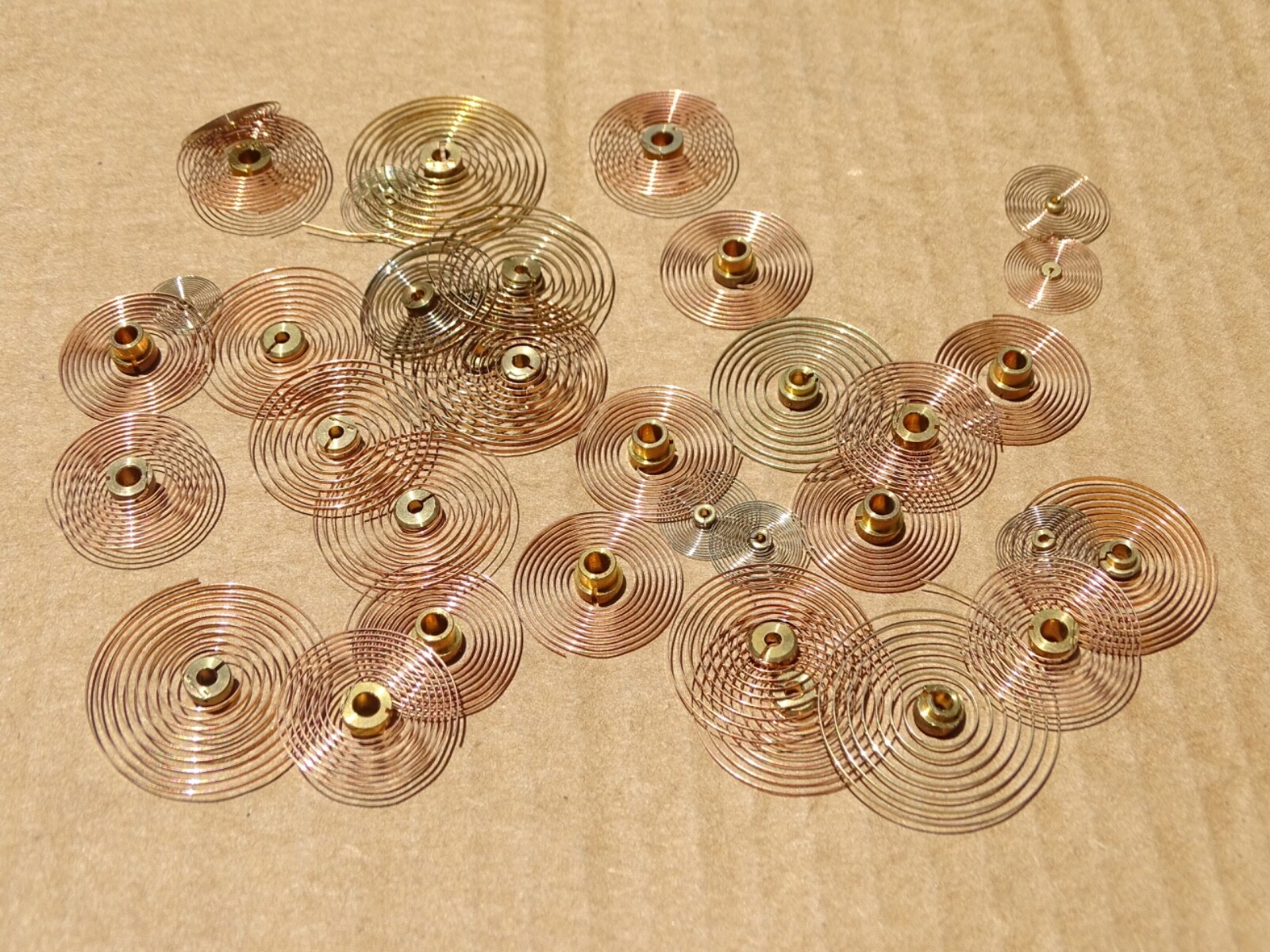 CLOCK HAIRSPRINGS, 30 + ASSORTED SIZES, W/ CENTER COLLETS, NICE CLEAN