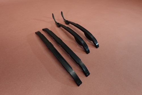 Black metal 1998-2015 Yamaha VStar V Star 650 XVS650 cam shaft timing chain guides on a brown surface.