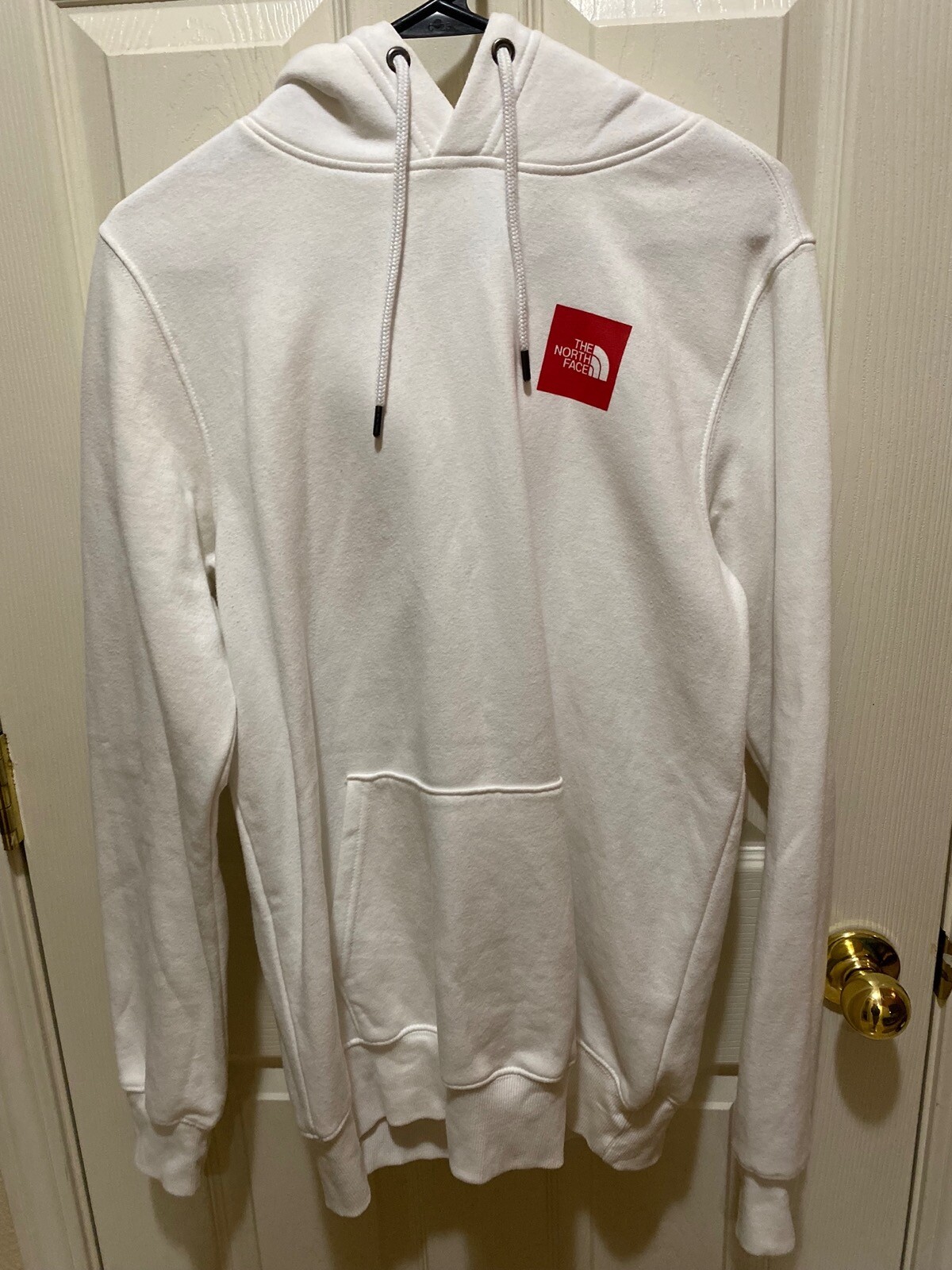 red and white north face hoodie