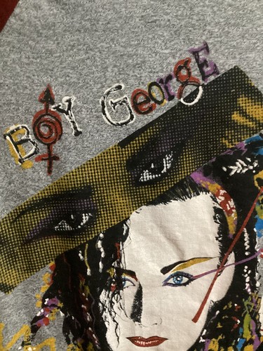 Gray long-sleeve shirt with “Boy George” text, yellow-red graphic, and blue-black eyes on front.
