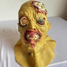 Horrible one-eyed zombie latex mask with rotten mouth and broken head