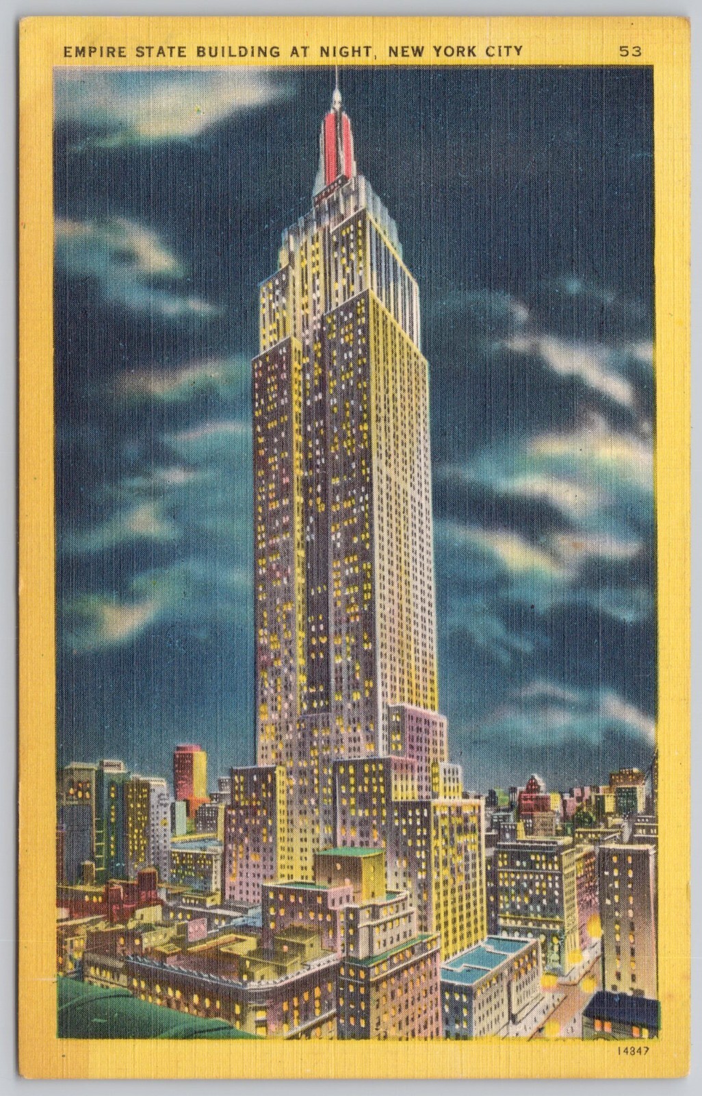 Discover NYC's Empire State Building illuminated at night on a linen postcard