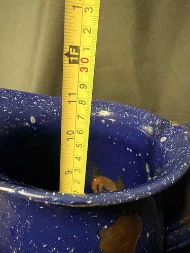 Yellow measuring tape inserted into a blue enamel granite pitcher, 5 qt capacity, with dark blue speckled pattern.