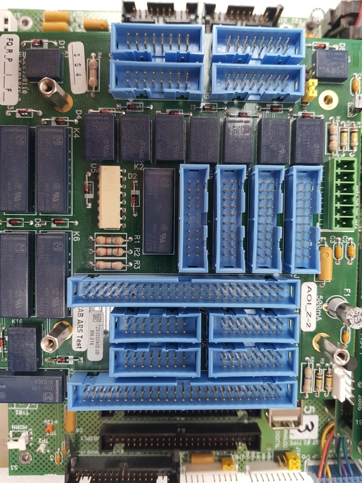 Add-on interface board with blue ribbon headers and relays on the AP14295 System I/O assembly