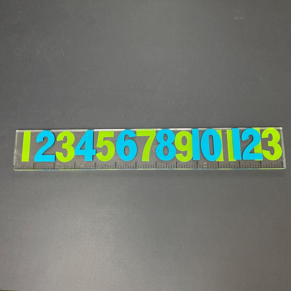 A George Nelson-designed Lucite ruler in clock-dial style — MCM design pedigree on a functional desk object you can actually use.
