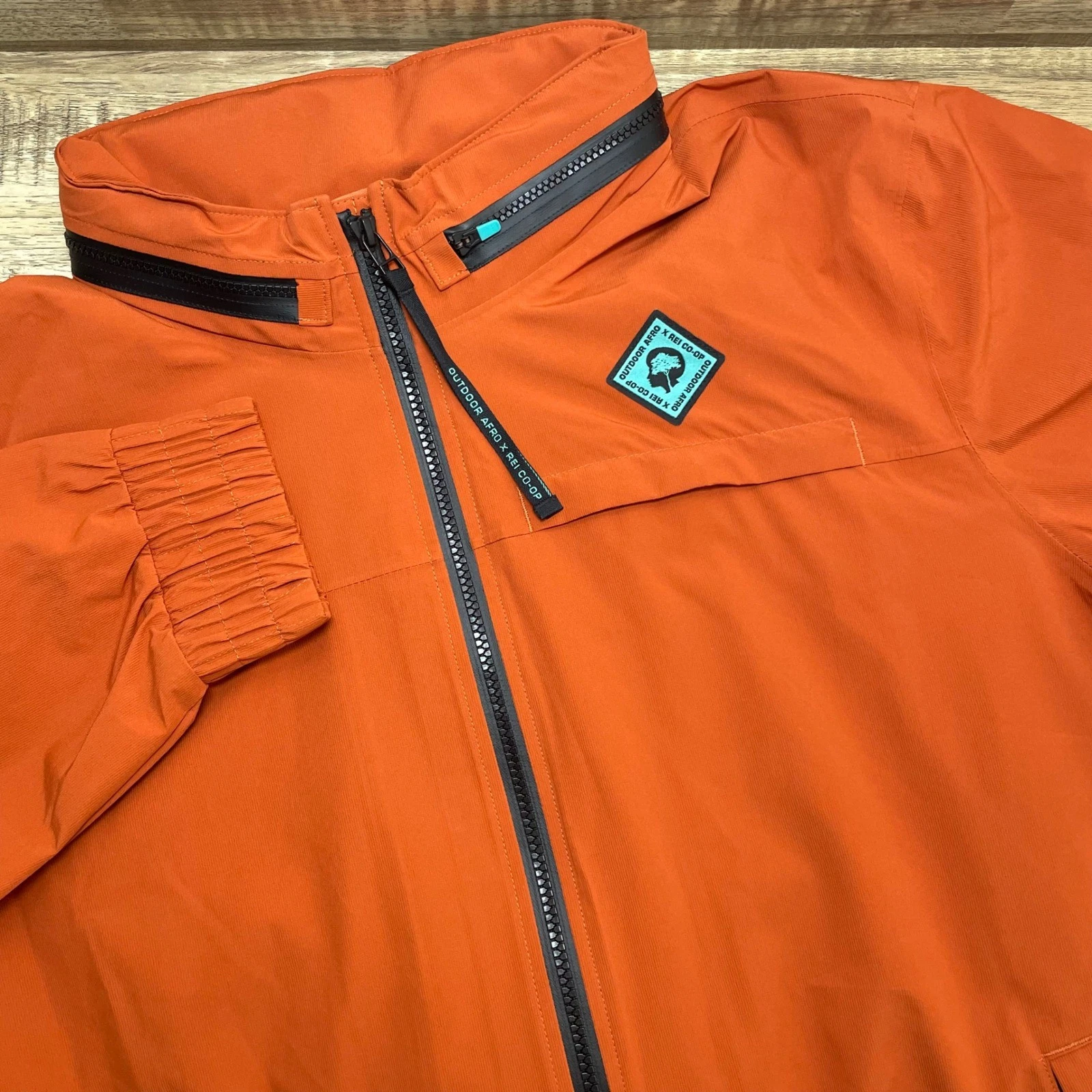 Outdoor Afro x REI Co-op Men Large Burnt Orange Packable Hood Windbreaker Jacket
