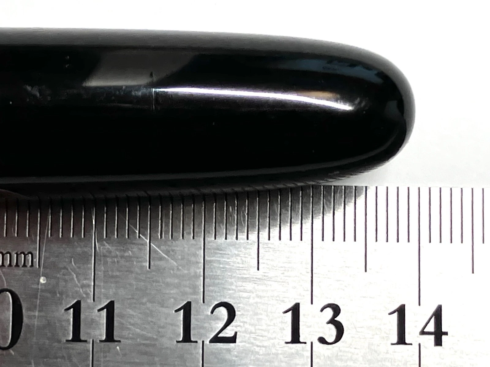 Black vintage ink shut off fountain pen with curved body, silver band, and white label showing size in millimeters.