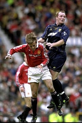 John Hartson of Wimbledon is challenged by Phil Neville of Manches- Old Photo