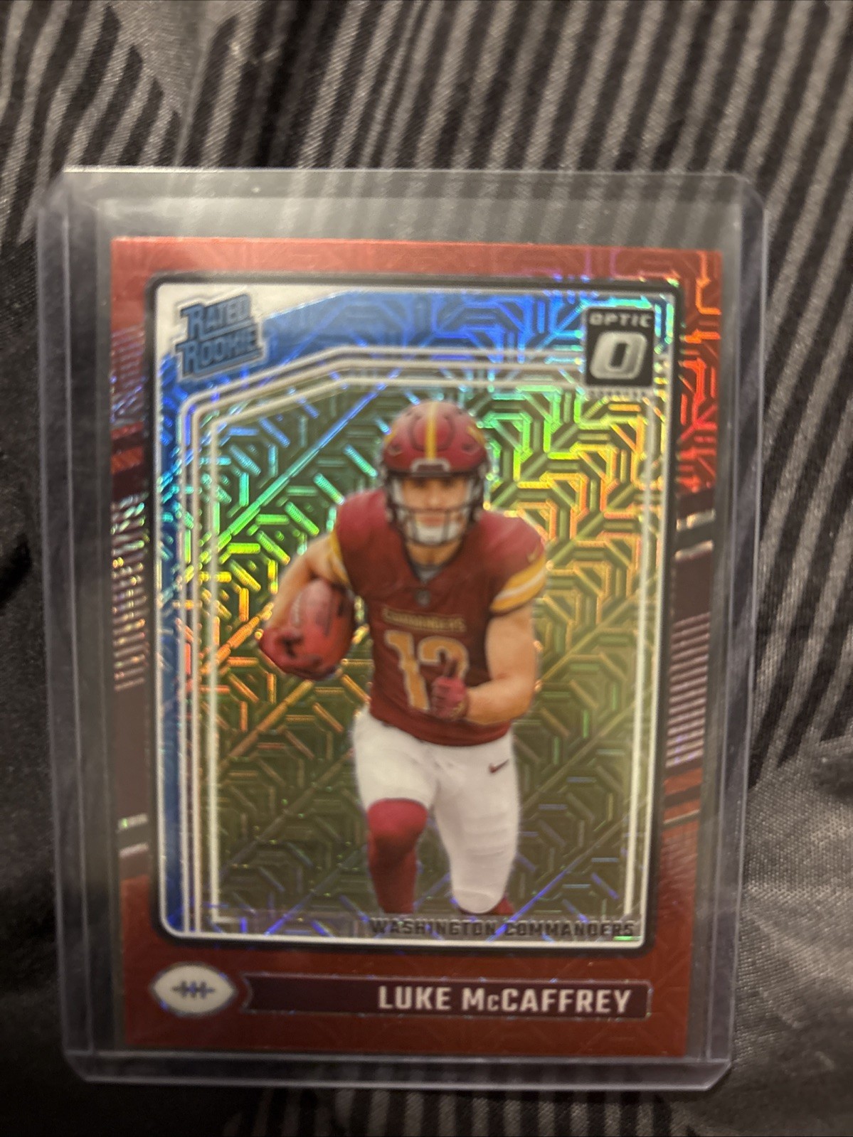 2024 Panini Donruss Optic - Rated Rookie Luke McCaffrey #268 Red Mojo Prizm (RC)