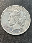 1927-D  PEACE DOLLAR WITH MINTAGE OF  1,268,900  (THIS COIN HAS BEEN POLISHED)
