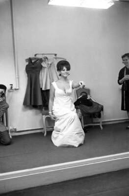 Claudia Cardinale in front of the mirror at Nina Ricci's fashion h- Old Photo