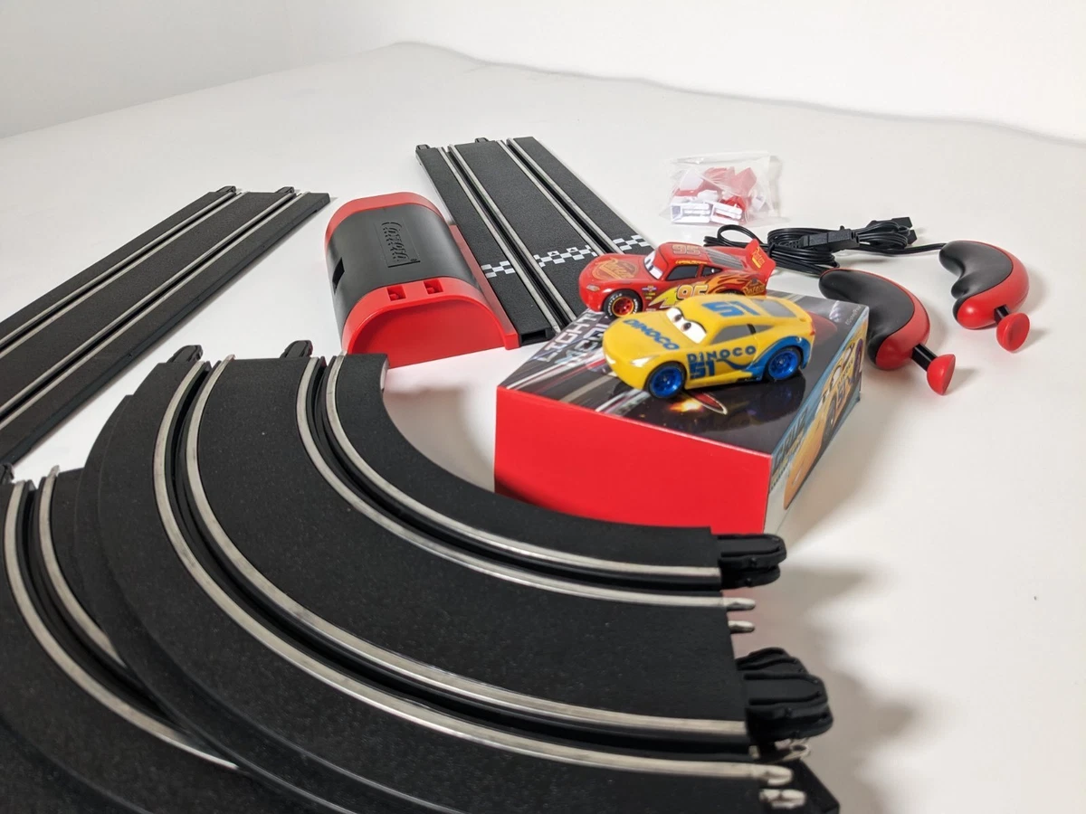 carrera first disney/pixar cars 3 slot car race track includes 2 cars:  lightning mcqueen and dinoco cruz batterypowered beginner racing set for  kids ages 3 years and up 