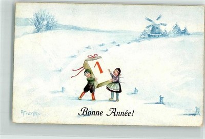 39786508 - Two Dutch children holding a calendar sheet in front of a windmill with