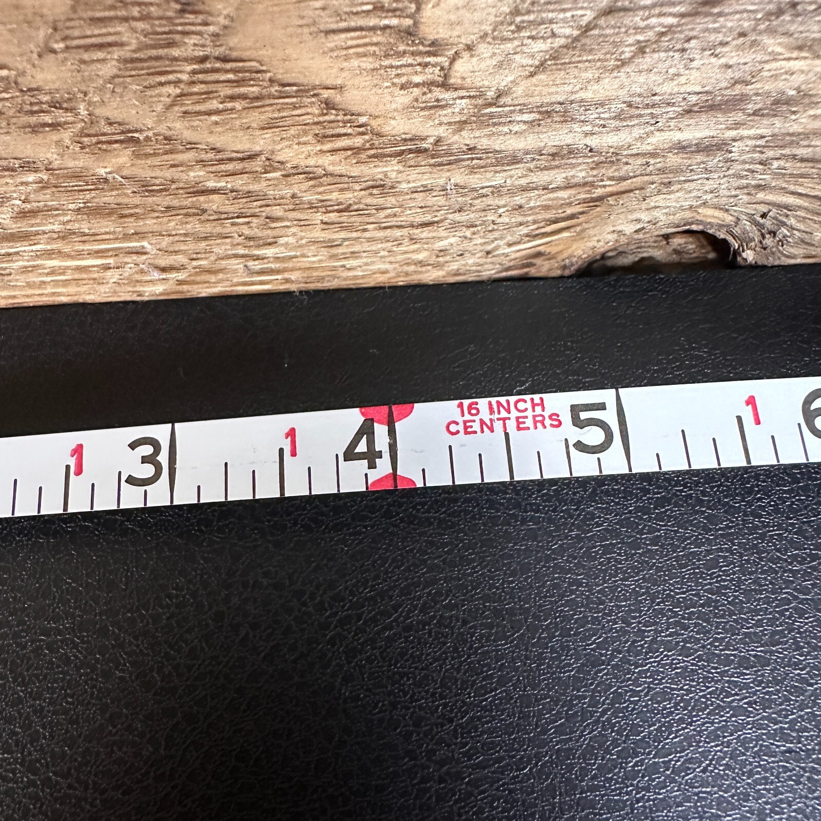 Vintage Stanley 50 foot hand crank tape measure with black and white label, 16 inch centers, and red vertical scale.