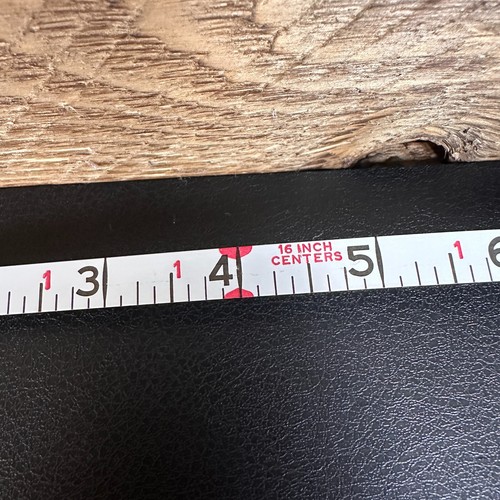 Vintage Stanley 50 foot hand crank tape measure with black and white label, 16 inch centers, and red vertical scale.