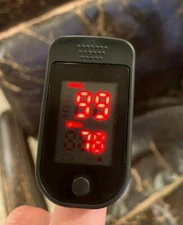 Pulse Oximeter with plastic pouch and instruction manual