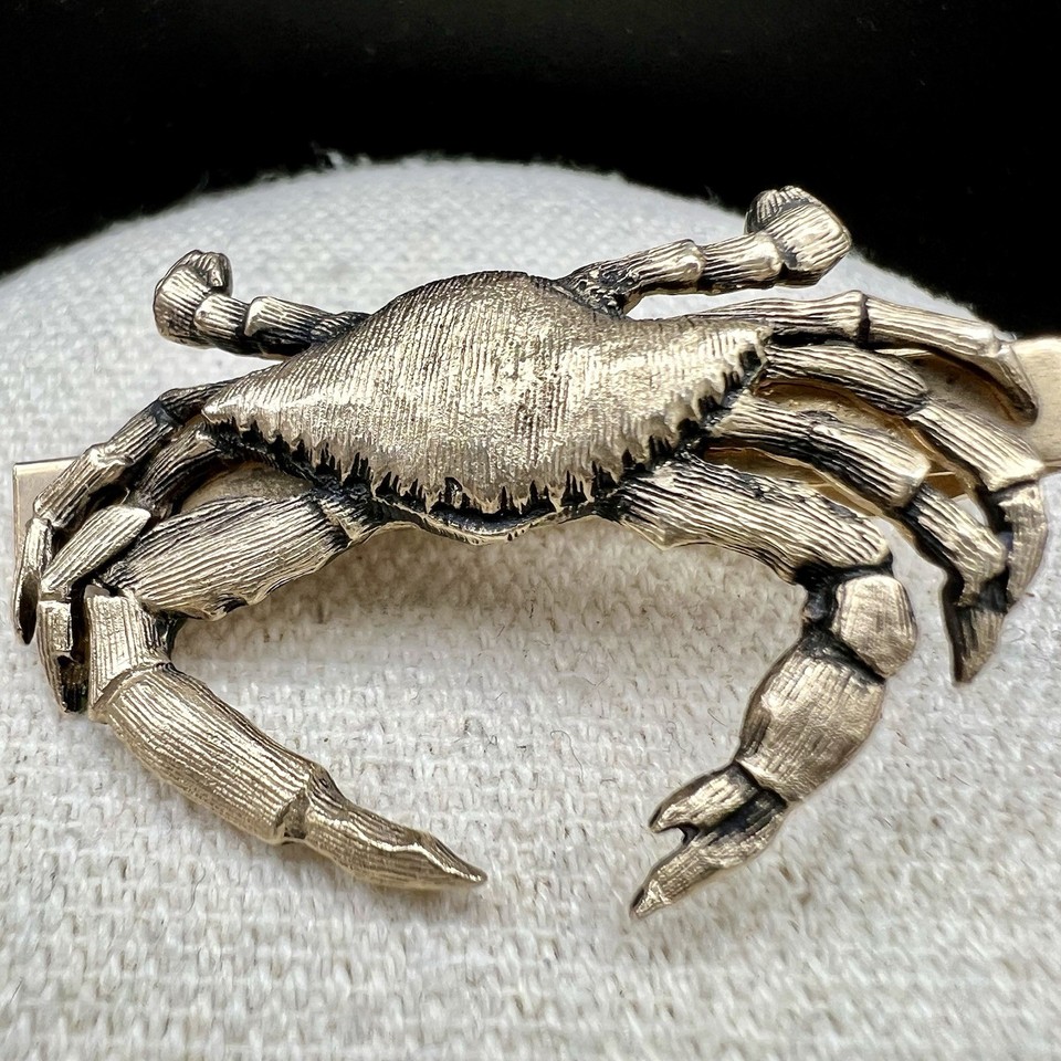 A gold-tone vintage blue crab tie clip that's specific, nautical, and charming — the kind of quirky menswear accent that actually starts conversations at dinner.