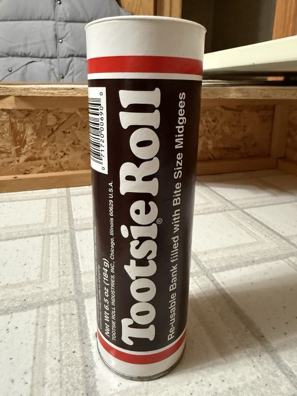 NEW TOOTSIE ROLL BANK 7.5 “ TALL PULP BOARD W/METAL BOTTOM & PLASTIC TOP PROMO