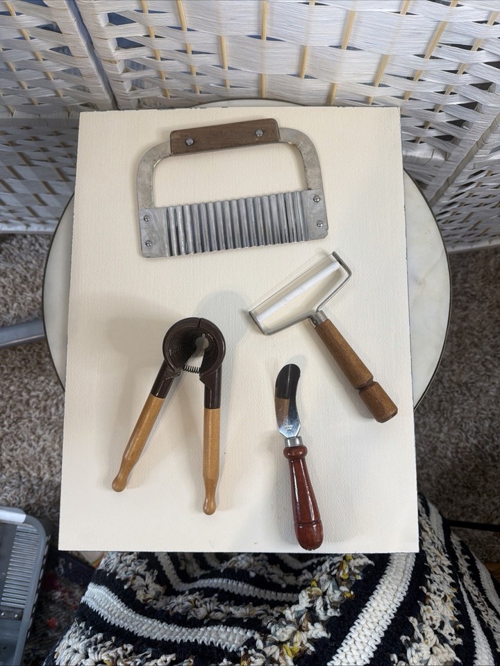 A matching set of 4 vintage stainless steel and wood kitchen tools — the kind of cohesive, tactile set that looks like it escaped a 1960s farmhouse kitchen and belongs on a open shelf display.