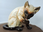 Siamese Cat cleaning her paw very beautiful figurine colors are realistic