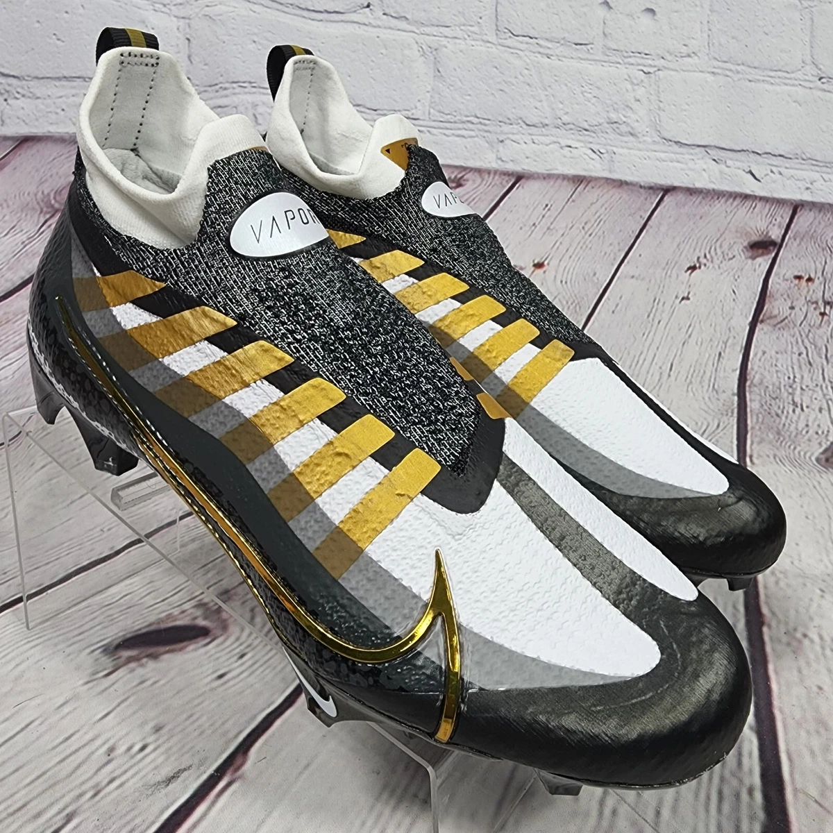 Nike gold and store black football cleats