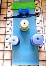 Stack of home free weights: discs/weightbelt, yoga mat & one single dumbbell