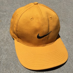 black nike hat with gold swoosh