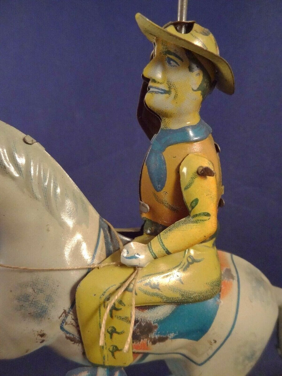 RARE ancien jouet en tôle mécanique cavalier / cow-boy à cheval
